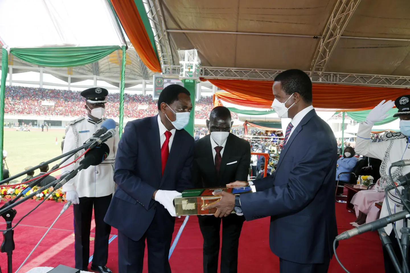 Hakainde Hichilema receiving instruments of power from outgoing President Edgar Chagwa Lungu